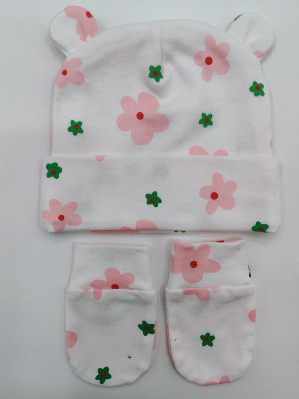 Vit bomullsmössa med björnöron och matchande vantar med rosa och grönt blommönster för baby.
