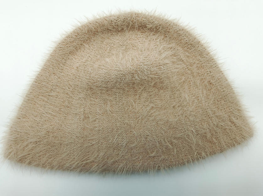 Beige fluffig stickad bucket hat med franstextur och mjukt pälsliknande material